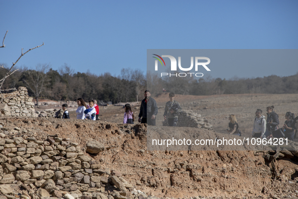 Hundreds of people are visiting the old town of Sant Roma de Sau, where normally the water of the Sau reservoir would almost completely cove...