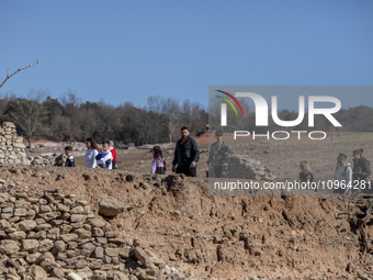 Hundreds of people are visiting the old town of Sant Roma de Sau, where normally the water of the Sau reservoir would almost completely cove...