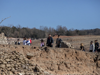 Hundreds of people are visiting the old town of Sant Roma de Sau, where normally the water of the Sau reservoir would almost completely cove...