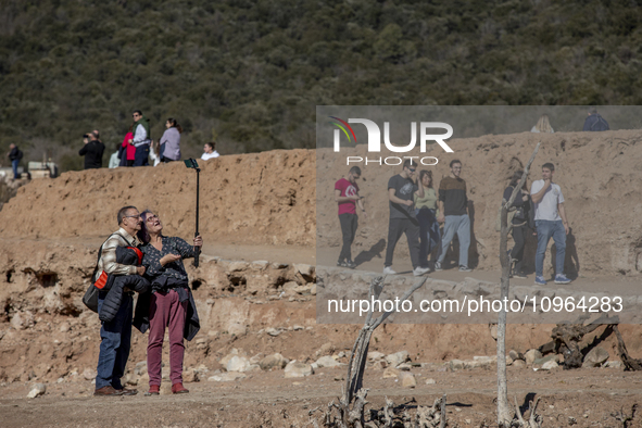 Hundreds of people are visiting the old town of Sant Roma de Sau, where normally the water of the Sau reservoir would almost completely cove...