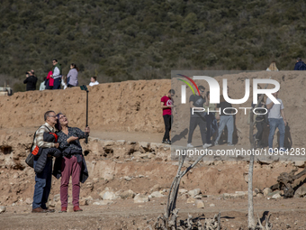 Hundreds of people are visiting the old town of Sant Roma de Sau, where normally the water of the Sau reservoir would almost completely cove...