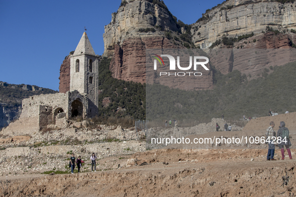 Hundreds of people are visiting the old town of Sant Roma de Sau, where normally the water of the Sau reservoir would almost completely cove...