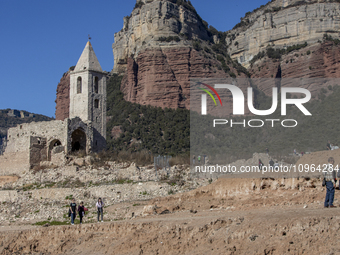 Hundreds of people are visiting the old town of Sant Roma de Sau, where normally the water of the Sau reservoir would almost completely cove...