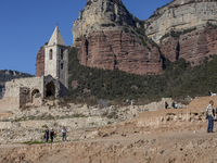 Hundreds of people are visiting the old town of Sant Roma de Sau, where normally the water of the Sau reservoir would almost completely cove...