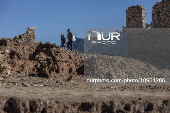 Hundreds of people are visiting the old town of Sant Roma de Sau, where normally the water of the Sau reservoir would almost completely cove...