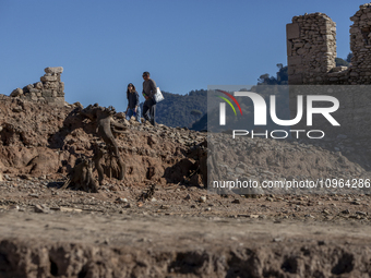 Hundreds of people are visiting the old town of Sant Roma de Sau, where normally the water of the Sau reservoir would almost completely cove...