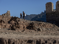 Hundreds of people are visiting the old town of Sant Roma de Sau, where normally the water of the Sau reservoir would almost completely cove...