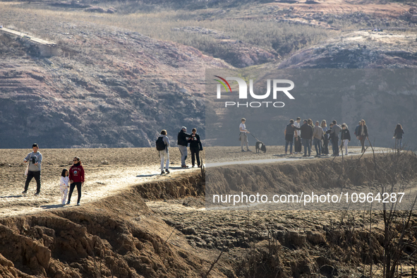 Hundreds of people are visiting the old town of Sant Roma de Sau, where normally the water of the Sau reservoir would almost completely cove...