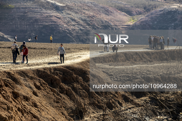 Hundreds of people are visiting the old town of Sant Roma de Sau, where normally the water of the Sau reservoir would almost completely cove...