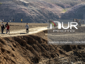 Hundreds of people are visiting the old town of Sant Roma de Sau, where normally the water of the Sau reservoir would almost completely cove...