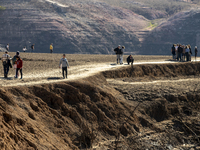 Hundreds of people are visiting the old town of Sant Roma de Sau, where normally the water of the Sau reservoir would almost completely cove...