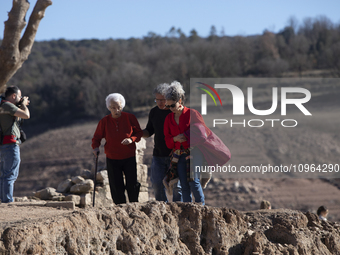 Hundreds of people are visiting the old town of Sant Roma de Sau, where normally the water of the Sau reservoir would almost completely cove...