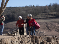 Hundreds of people are visiting the old town of Sant Roma de Sau, where normally the water of the Sau reservoir would almost completely cove...