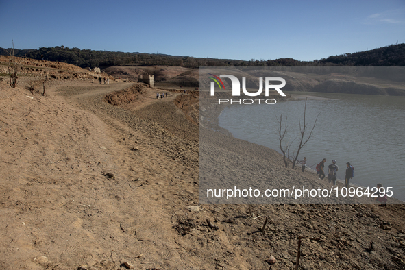 Hundreds of people are visiting the old town of Sant Roma de Sau, where normally the water of the Sau reservoir would almost completely cove...