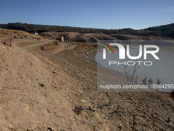 Hundreds of people are visiting the old town of Sant Roma de Sau, where normally the water of the Sau reservoir would almost completely cove...