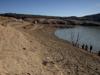 Hundreds of people are visiting the old town of Sant Roma de Sau, where normally the water of the Sau reservoir would almost completely cove...