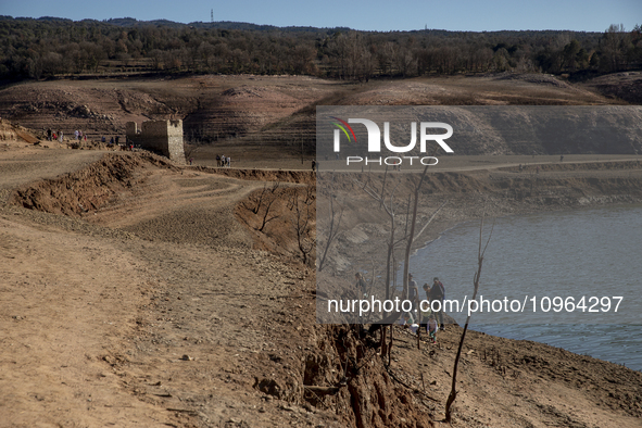 Hundreds of people are visiting the old town of Sant Roma de Sau, where normally the water of the Sau reservoir would almost completely cove...