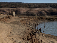 Hundreds of people are visiting the old town of Sant Roma de Sau, where normally the water of the Sau reservoir would almost completely cove...