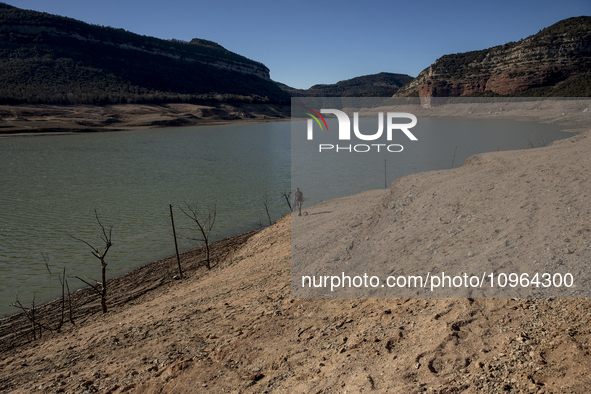 Hundreds of people are visiting the old town of Sant Roma de Sau, where normally the water of the Sau reservoir would almost completely cove...