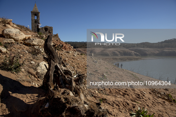 Hundreds of people are visiting the old town of Sant Roma de Sau, where normally the water of the Sau reservoir would almost completely cove...