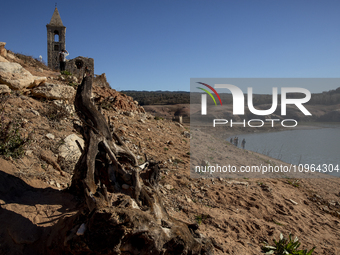 Hundreds of people are visiting the old town of Sant Roma de Sau, where normally the water of the Sau reservoir would almost completely cove...