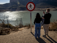 Hundreds of people are visiting the old town of Sant Roma de Sau, where normally the water of the Sau reservoir would almost completely cove...