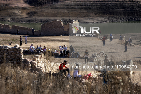 Hundreds of people are visiting the old town of Sant Roma de Sau, where normally the water of the Sau reservoir would almost completely cove...