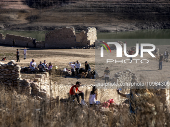 Hundreds of people are visiting the old town of Sant Roma de Sau, where normally the water of the Sau reservoir would almost completely cove...