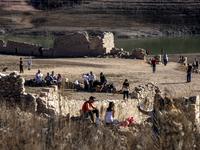 Hundreds of people are visiting the old town of Sant Roma de Sau, where normally the water of the Sau reservoir would almost completely cove...