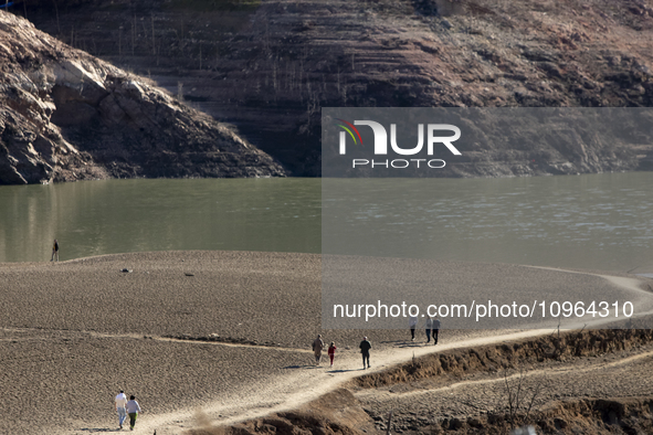 Hundreds of people are visiting the old town of Sant Roma de Sau, where normally the water of the Sau reservoir would almost completely cove...