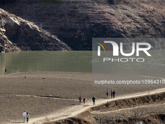 Hundreds of people are visiting the old town of Sant Roma de Sau, where normally the water of the Sau reservoir would almost completely cove...