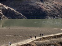 Hundreds of people are visiting the old town of Sant Roma de Sau, where normally the water of the Sau reservoir would almost completely cove...