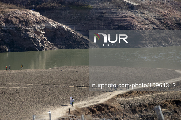 Hundreds of people are visiting the old town of Sant Roma de Sau, where normally the water of the Sau reservoir would almost completely cove...