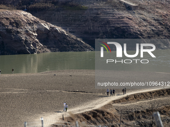 Hundreds of people are visiting the old town of Sant Roma de Sau, where normally the water of the Sau reservoir would almost completely cove...