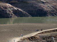 Hundreds of people are visiting the old town of Sant Roma de Sau, where normally the water of the Sau reservoir would almost completely cove...