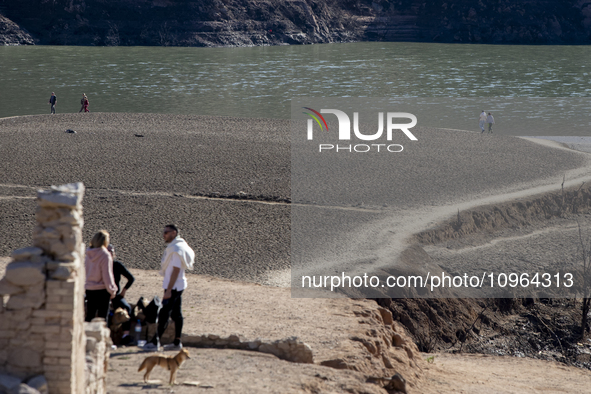 Hundreds of people are visiting the old town of Sant Roma de Sau, where normally the water of the Sau reservoir would almost completely cove...