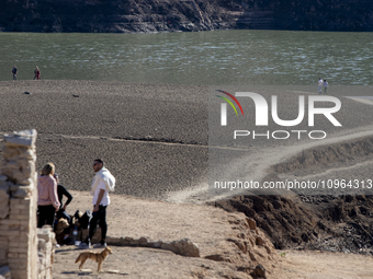 Hundreds of people are visiting the old town of Sant Roma de Sau, where normally the water of the Sau reservoir would almost completely cove...