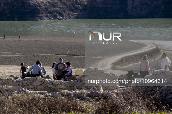 Hundreds of people are visiting the old town of Sant Roma de Sau, where normally the water of the Sau reservoir would almost completely cove...