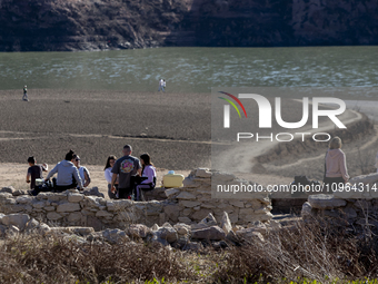 Hundreds of people are visiting the old town of Sant Roma de Sau, where normally the water of the Sau reservoir would almost completely cove...