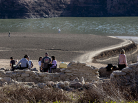 Hundreds of people are visiting the old town of Sant Roma de Sau, where normally the water of the Sau reservoir would almost completely cove...