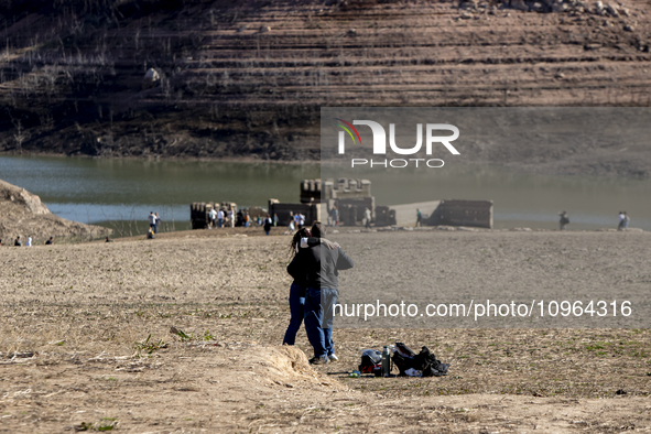 Hundreds of people are visiting the old town of Sant Roma de Sau, where normally the water of the Sau reservoir would almost completely cove...