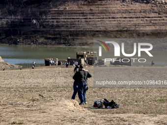 Hundreds of people are visiting the old town of Sant Roma de Sau, where normally the water of the Sau reservoir would almost completely cove...