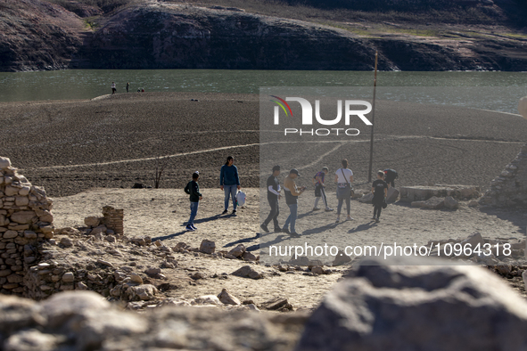 Hundreds of people are visiting the old town of Sant Roma de Sau, where normally the water of the Sau reservoir would almost completely cove...