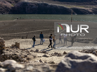 Hundreds of people are visiting the old town of Sant Roma de Sau, where normally the water of the Sau reservoir would almost completely cove...