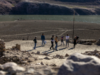 Hundreds of people are visiting the old town of Sant Roma de Sau, where normally the water of the Sau reservoir would almost completely cove...