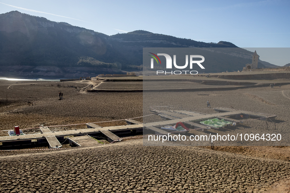 Hundreds of people are visiting the old town of Sant Roma de Sau, where normally the water of the Sau reservoir would almost completely cove...