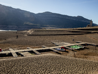 Hundreds of people are visiting the old town of Sant Roma de Sau, where normally the water of the Sau reservoir would almost completely cove...