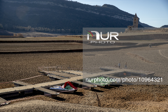 Hundreds of people are visiting the old town of Sant Roma de Sau, where normally the water of the Sau reservoir would almost completely cove...