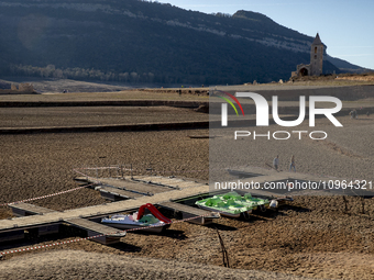 Hundreds of people are visiting the old town of Sant Roma de Sau, where normally the water of the Sau reservoir would almost completely cove...