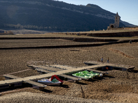 Hundreds of people are visiting the old town of Sant Roma de Sau, where normally the water of the Sau reservoir would almost completely cove...